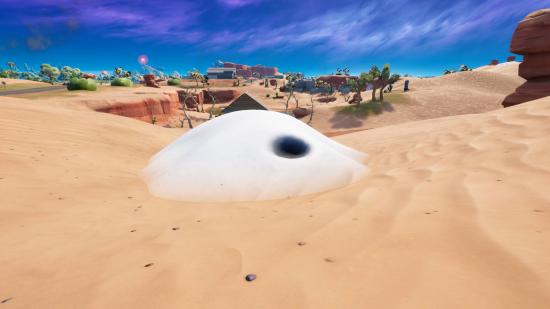 Fortnite sand mounds locations: a small bump with a hole in a desert. The ones in-game are covered in sand, while this one is covered in snow.