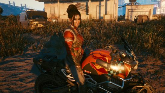 Cyberpunk 2077 expansion: Panam Palmer sits astride a motorcycle in the scrubland outside Night City in Cyberpunk 2077
