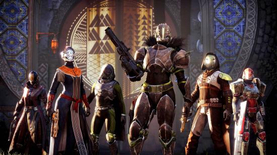 Destiny 2 weekly reset times - a group of six guardians posing in front of a banner. One of them is holding a gun.