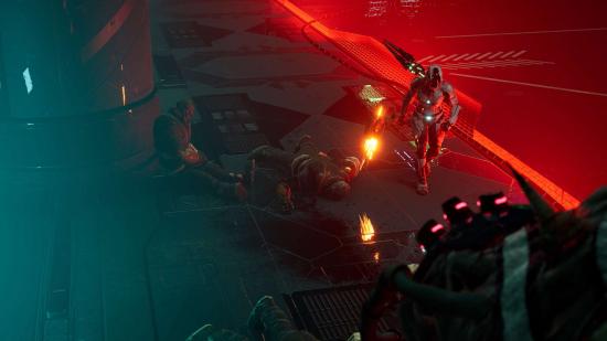 The hero of Dolmen walks through an eerie sci-fi room with red lighting