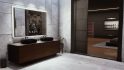 Vampire The Masquerade Swansong review: an official screenshot from Big Bad Wolf depicts a bathroom in a modern, minimalist apartment, the residence of a wealthy Boston banker; a large smart mirror depicts the day's weather over two granite sinks, and the walls and floor tiles are of pristine white marble
