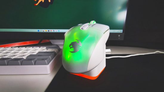 The best RGB wireless gaming mouse is the Roccat Kone XP Air, seen here sitting on top of its charging dock, shining green