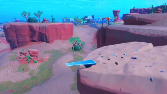 Fortnite diving board locations: a diving board on top of a cliff in the desert.