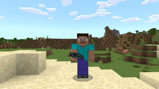 Minecraft recovery compass - Steve is holding the recovery copmpass, which is pointing to the east.