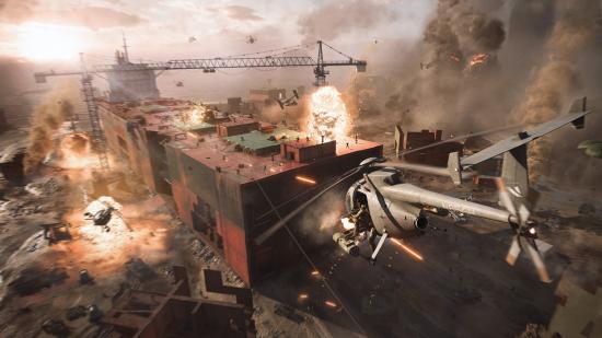 Battlefield 2042 update 1.0: An attack helicopter fires at a battle in a shipping yard dominated by a large stack of shipping containers.