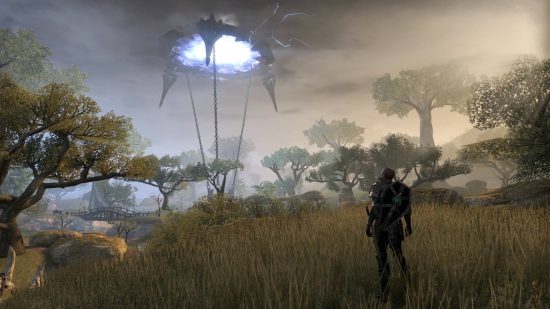 Best single-player MMOs: The Elder Scrolls Online. A figure in a field gazes at a portal suspended in the clouded sky, chained to the earth as blue light emits from the entrance.