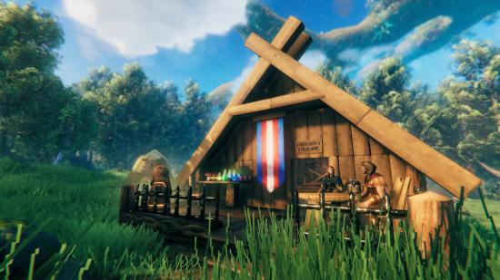 Valheim update save file fix: A wooden house in Valheim displays a trans pride flag as two Vikings sit outside together on the porch.