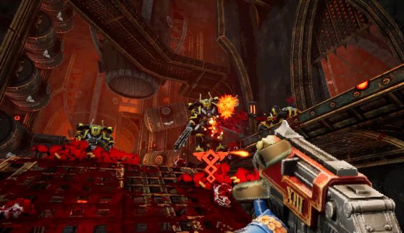 Warhammer 40k: Boltgun reveal trailer: Three chaos space marines in black and gold armour approach at the top of a ramp in a massive factory, the characters are rendered in pixelated '90s art style.