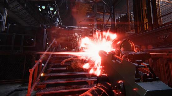 Warhammer 40K Darktide hands-on: A lasgun fires a bright red blast deep within an underground manufacturing facility