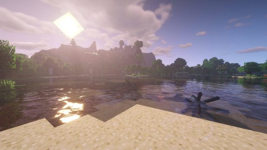 Best Minecraft shaders: the BSL shader shows a lake near a mountain at sunset. Some squid swim in the water.