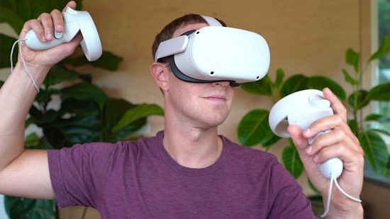 Meta CEO Mark Zuckerberg wearing a Meta Quest 2 VR headset, wielding two controllers