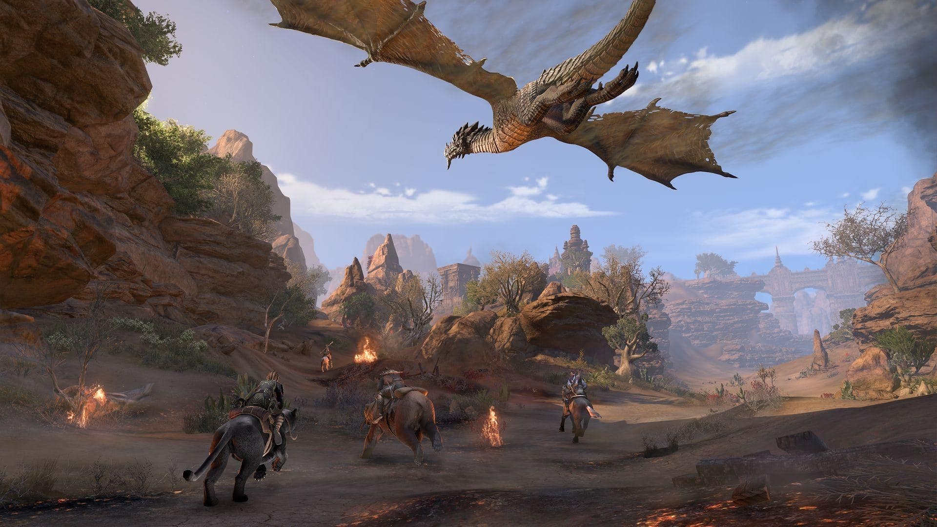Best dragon games: The Elder Scrolls Online. Image shows a dragon flying overhead while characters riding different creatures ride below.