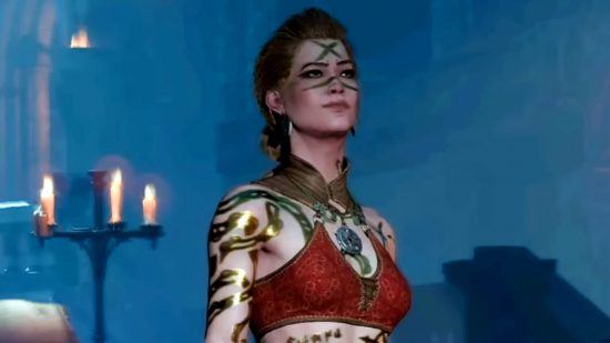 Diablo 4 survey - a female character with a red top, decorative gold wraps across their arms, a gld colour, and a cross painted on their forehead