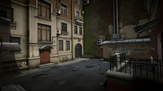 Escape from Tarkov screenshots: The back side of a residential building downtown, with a hopscotch pattern chalked in pink around a manhole cover and graffiti covering a low shed by a high brick wall