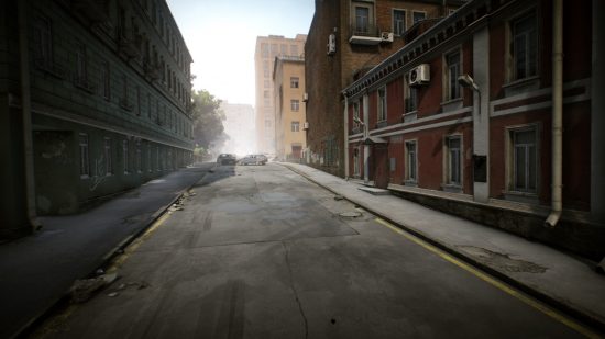 Escape from Tarkov screenshots: An empty city street, with a red building with white trim on the right and a blue building on the left. The street disappears in the mist in the distance, and two crashed cars can be seen near the intersection ahead