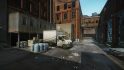 Escape from Tarkov screenshots: A large panel truck in a loading area in an alleyway lined by the walls of a large red brick industrial building