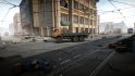 Escape from Tarkov screenshots: A large orange flatbed utility truck parked in the street underneath tram lines in front of a tall downtown building