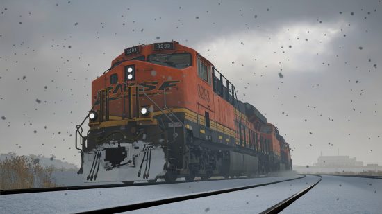 Train Sim World 3 release date: A red BNSF locomotive at the head of a train moving through a snow storm.