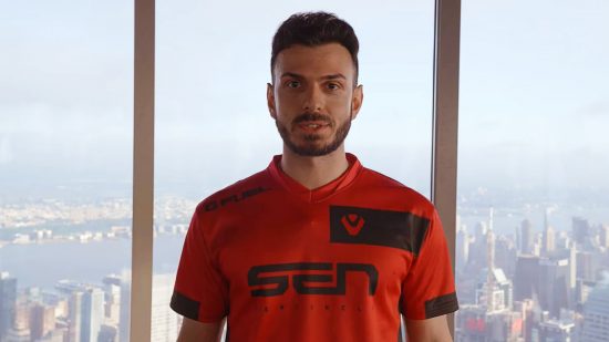Twitch streamer Tarik joins Sentinels Valorant following CSGO career: Man stands against New York City skyline in red and black jersey