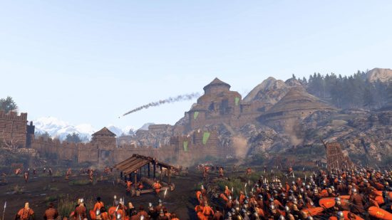 Mejores juegos medievales: un ejército en rojo está asedio a un pueblo en el Monte y la Blade 2: Bannerlord