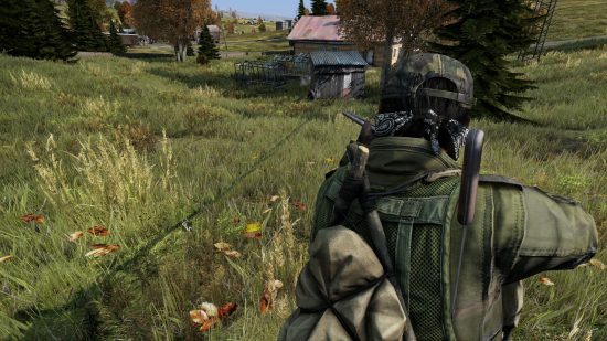 Best survival games: DayZ. Image shows a soldier with a gun in a field.