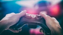 U.S. Homeland Security awards grant for preventing extremism in games: A white man holds an Xbox controller in both hands