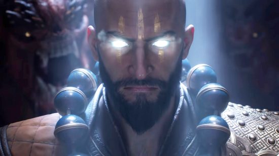 Diablo Immortal update leak hints at new Helliquary boss, Frozen Heart returns: A bald man with glowing blue eyes looks into the camera, also wearing gold warpaint and a necklace made of large black balls
