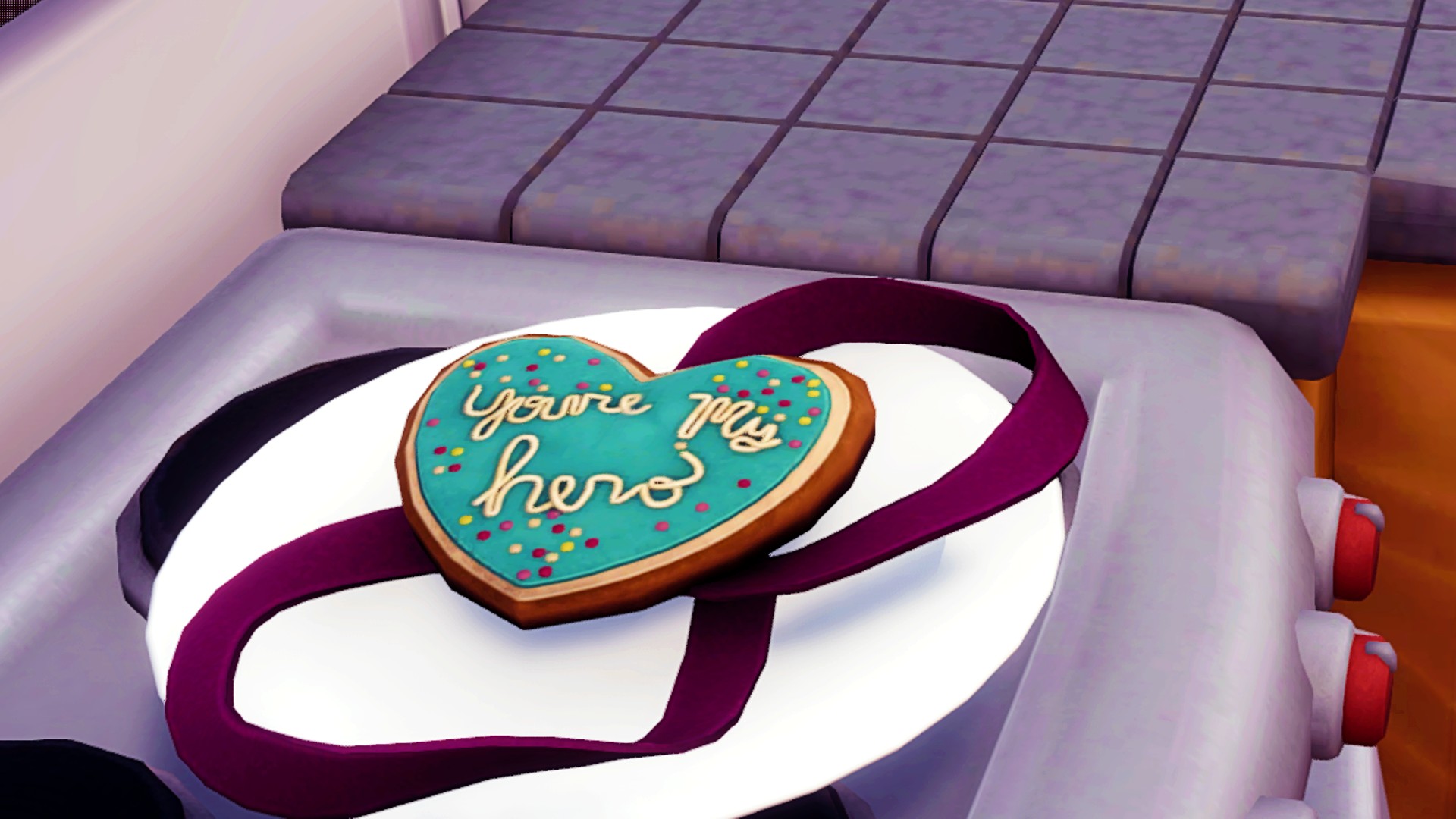 Disney Dreamlight Valley three star recipes: My Hero Cookie, the word's "you're my hero" in cream on a teal icing background, on a heart-shaped cookie, a reference to the cookie in Wreck it Ralph.