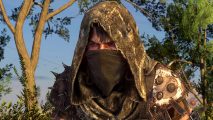 Dying Light 2 update fixes final cutscene crash bug: A figure wearing a threadbare hood and spiked armour peers out from over a bandanna that obscures their face