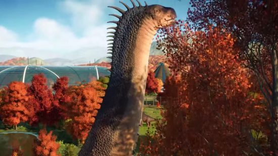 Jurassic World Evolution 2 expansion: A giant Alamosaurus, with spines running down its long neck, browses for leaves to eat at the top of a tree canopy inside a park enclosure