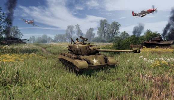 WW2 RTS Men of War 2 delayed: An M26 Pershing tank in a grassy field of wildflowers, with a fighter plane in the sky in the background