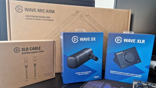 The Elgato Wave DX microphone in its blue box, surrounded by boxed accessories like the Wave XLR interface, and XLR cable, and the Wave Mic Arm