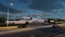 American Truck Simulator Texas DLC Space Program: From the highway, a large aircraft with a space shuttle mounted on top for transport can be seen at a Texas space facility
