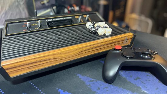 Custom Atari 2600 gaming PC with DnD dice sitting on top and VCS controller at right hand side