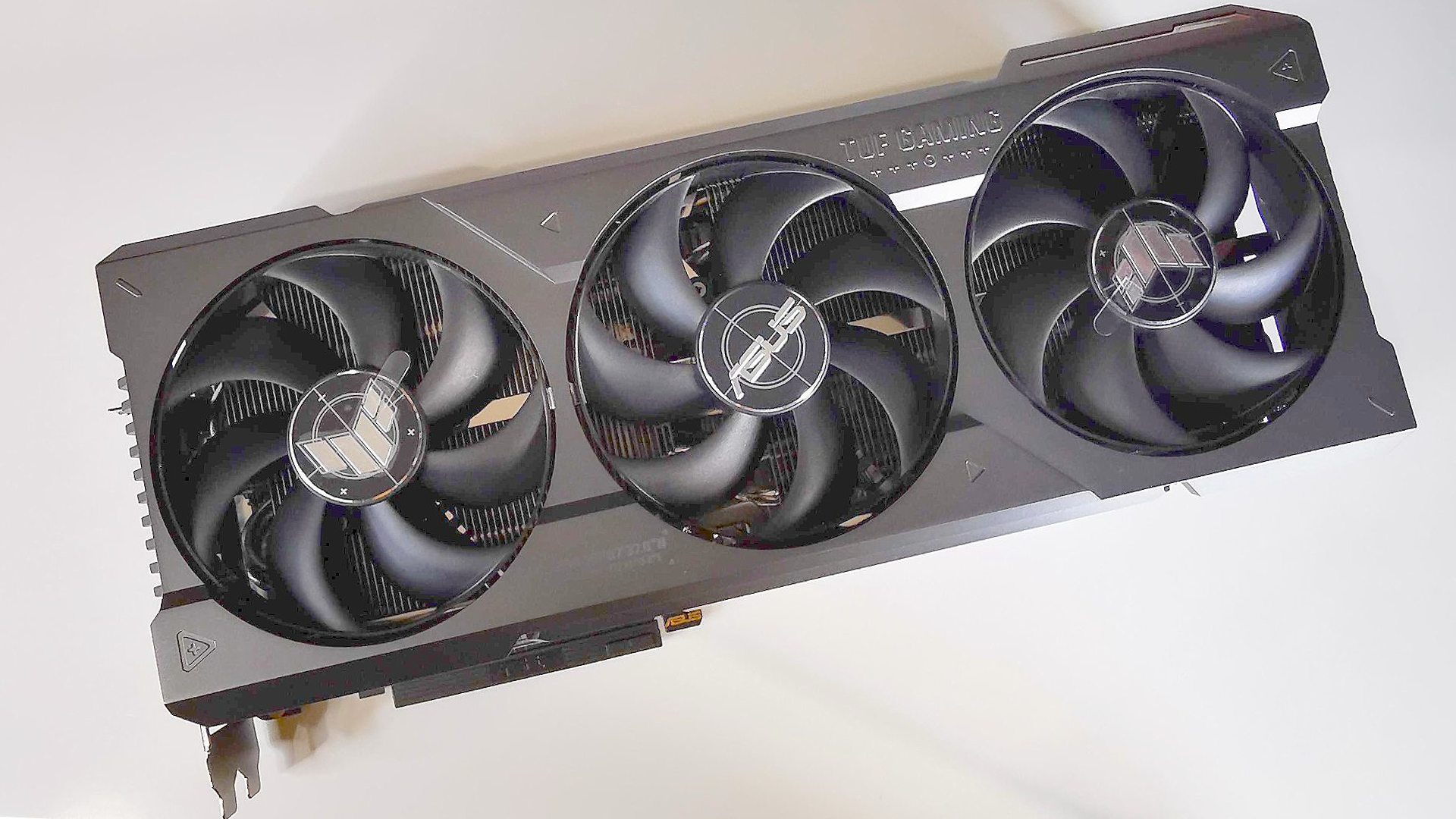 best graphics card: Nvidia RTX 4090 Asus TUF gaming model on white surface 