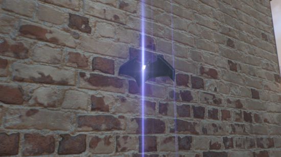 Gotham Knights Batarangs: a bat-shaped throwing weapon is wedged into some brick. There is a glowing purple light emitting from its crest.