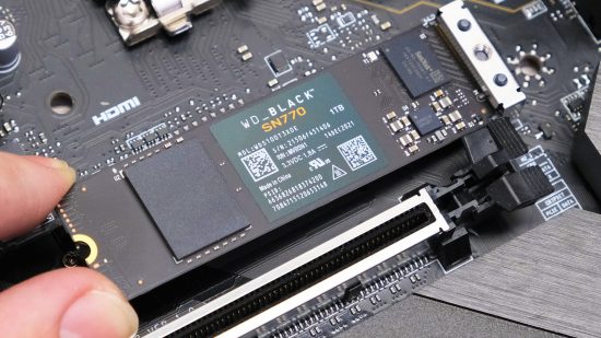 a picture showing someone installing an M.2. SSD