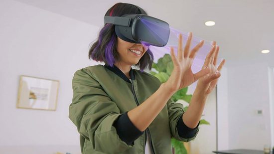 A woman wearing the Meta Quest 2 VR headset looks at her hands without controllers, showcase hand tracking