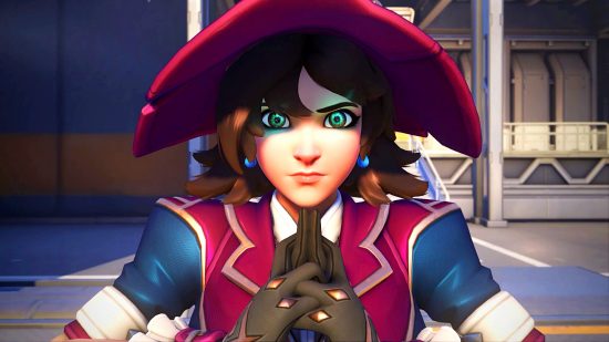 Overwatch 2 patches slow - Kiriko in her witch skin, her hands and forefingers pressed together as she stares forwards with her eyes glowing bright turquoise