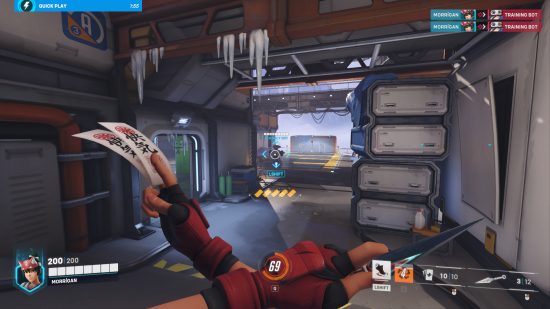 Overwatch 2 review: A woman holding ninja stars and tokens on her chest looks at a robot