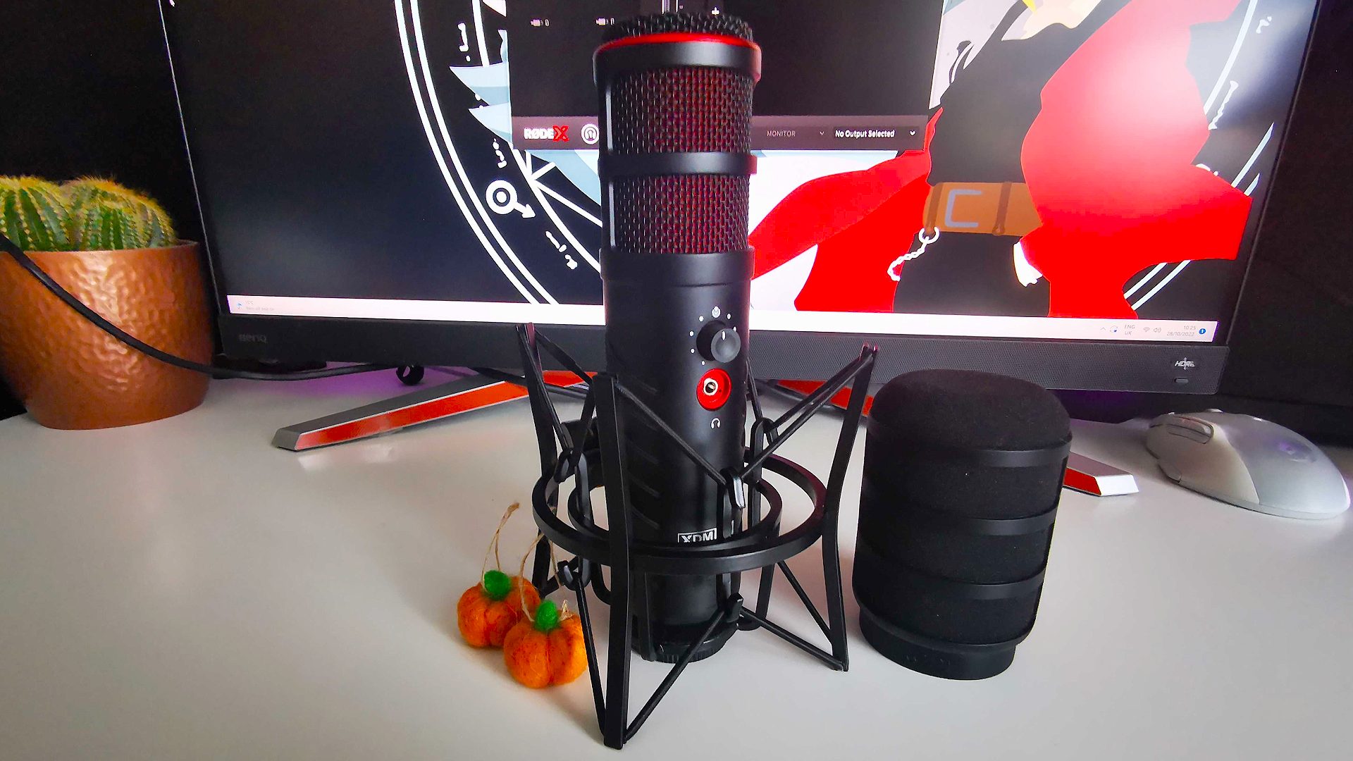 Rode X XDM-100 gaming mic with shockmount and pop filter on white desk