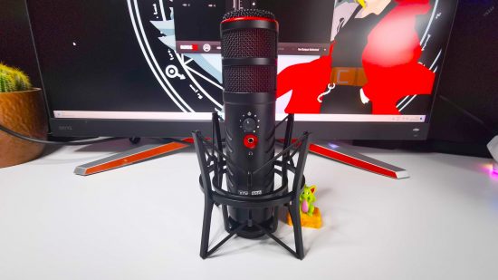 Rode X XDM-100 gaming mic with shockmount on white desk next to Pocket Dragon toy