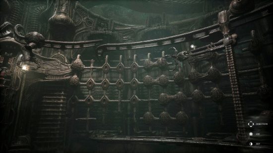 Scorn first puzzle: The biomechanical claw machine featured in the first puzzle in Scorn, mounted to a wall with a number of eggs attached to a grid structure.
