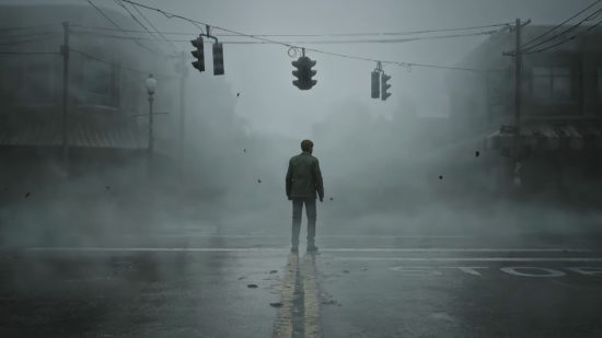 Silent Hill 2 remake announcement: A man, James Sunderland, stands beneath the traffic lights in an intersection in a foggy, abandoned town