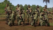 Arma 3 mod Vietnam DLC: A group of soldiers in camouflage poses with weapons ready at a forward operating base in Vietnam