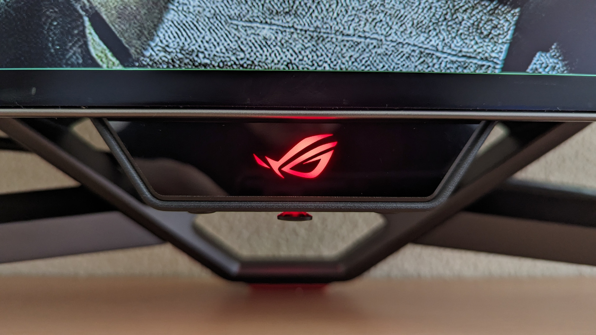 A close up of the power LED indicator on the Asus ROG Swift PG48UQ gaming monitor