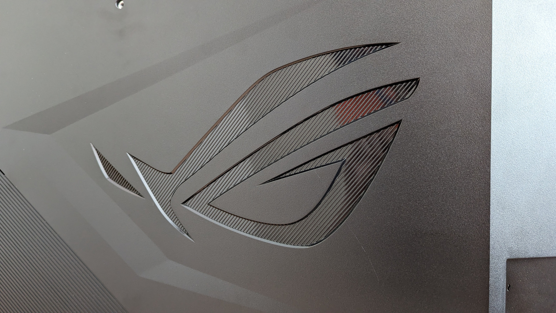 A close up of the Asus ROG logo on the back of the Swift PG48UQ gaming monitor
