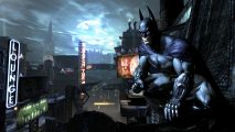Kevin Conroy has passed away: Batman crouches on the eaves of a tall gothic building in front of a full moon breaking through the clouds at night in Gotham City