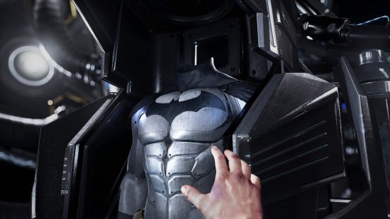 Best Batman games - A hand reaching out for Batman's suit in Batman Arkham VR.