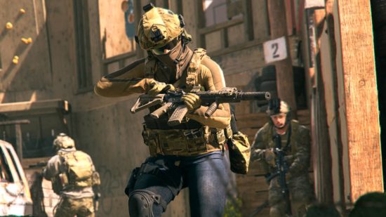 Best Warzone 2 battle rifles - a soldier reloading his gun as he walks through a town with sandstone buildings. Other soldiers follow close behind.